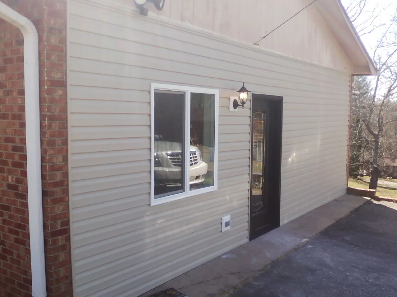 New vinyl siding and entry door on a room addition in Miamisburg