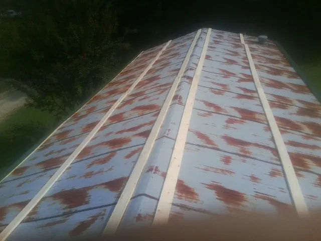 Rusted metal roof panels with new wood purlins before replacement — Storm Damage Roof Repair in Miamisburg by Roofing Brothers
