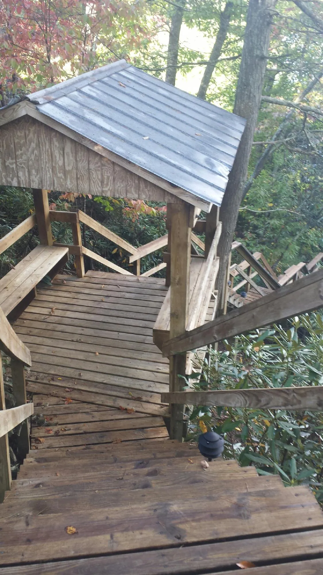Metal roofed shelter over wooden steps on a wooded walkway — Skylight Repair & Installation work by our crew in Miamisburg