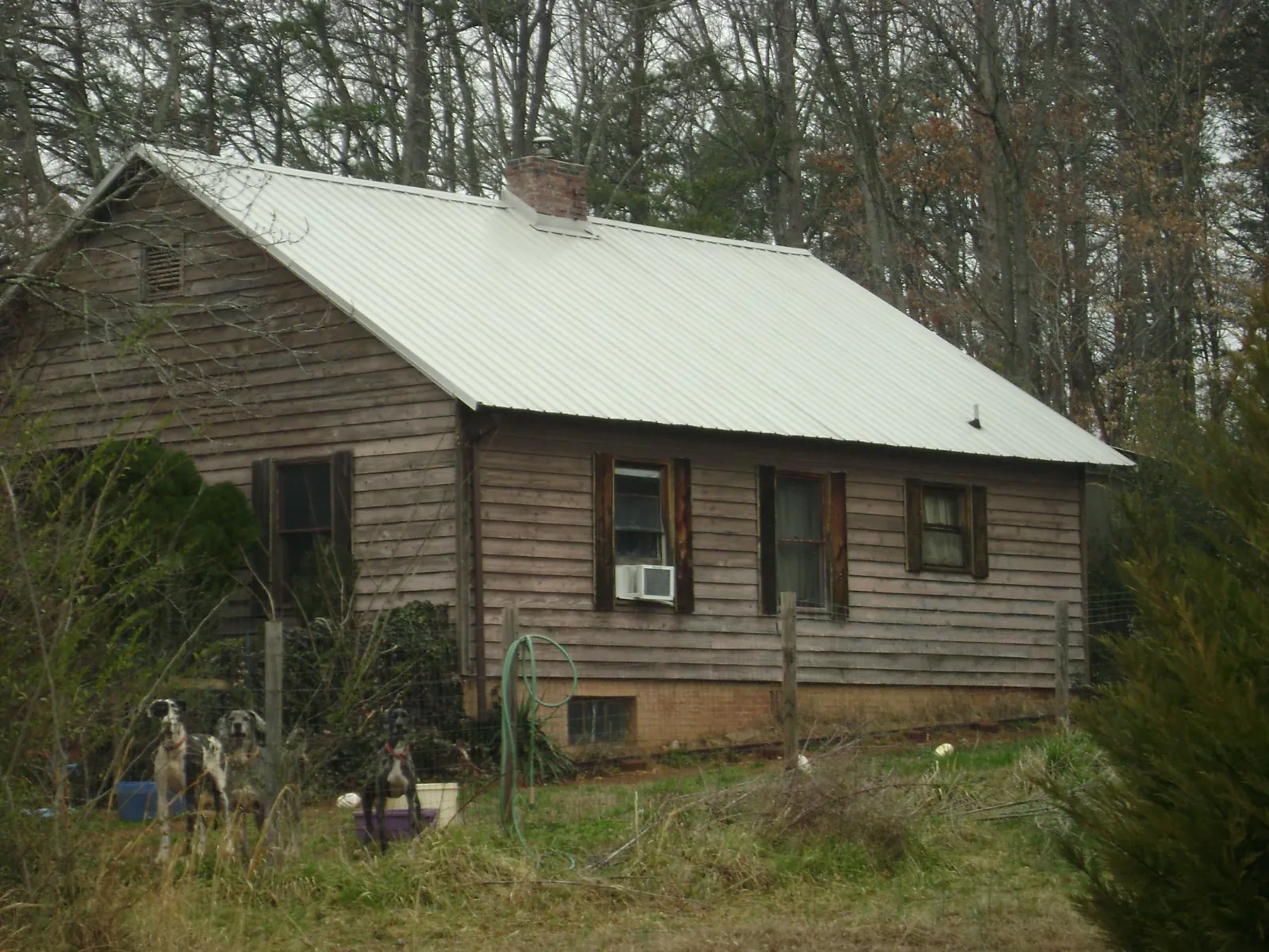 White metal roof on an old wood sided farmhouse, from a Metal Roof Installation job in Miamisburg